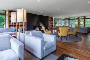 a living room with couches and chairs and a fireplace at Hotel Xalet del Golf in Puigcerdà +94 photos