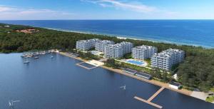 an aerial view of a resort on a body of water at Rogowo Pearl Apartament Resko in Rogowo