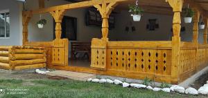 a wooden fence in front of a house at La Lenuța În Susani in Breb