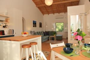 a kitchen and living room with a table and chairs at BLUE SKY COTTAGE, Kanouli beach in Halikounas +33 photos