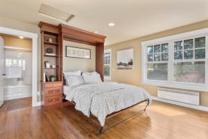 a bedroom with a bed and two windows at @ Marbella Lane - Waterfront Studio Whidbey Island in Coupeville