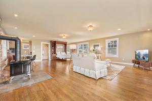 a living room with white furniture and a fireplace at @ Marbella Lane - Waterfront Studio Whidbey Island in Coupeville