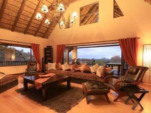 a living room with a couch and a table at Mingwe Private Game Lodge in Mabula