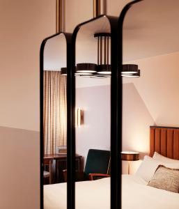 a hotel room with a bed and a mirror at The Hoxton, Holborn in London