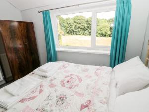 a bedroom with a bed and a window at 2 Thompsons Buildings in Choppington