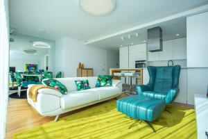 a living room with a couch and a chair at Ocean 52 by Rent4All in Figueira da Foz