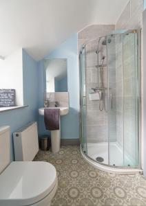 a bathroom with a shower and a toilet and a sink at Portrush Penthouse in Portrush