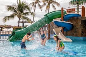 a group of people in the water at a water park at Barceló Huatulco in Santa Cruz Huatulco