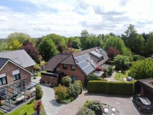 an aerial view of a house with solar panels on its roof at Ferienhaus Wieke in Wiesmoor
