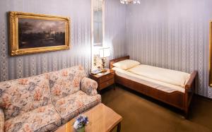 Postel nebo postele na pokoji v ubytování Hotel Palais Porcia