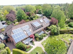 an aerial view of a house with solar panels on the roof at Ferienhaus Wieke in Wiesmoor
