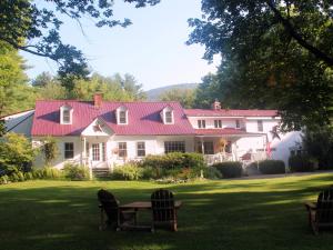 a large white house with a red roof at Buttonwood Inn on Mount Surprise in North Conway