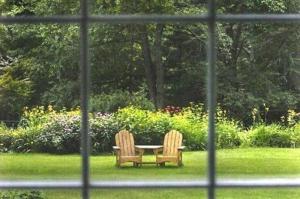 two chairs sitting around a table in the grass at Buttonwood Inn on Mount Surprise in North Conway