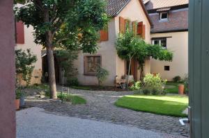 an outside view of a house with a garden at Au Grès des Vignes in Turckheim