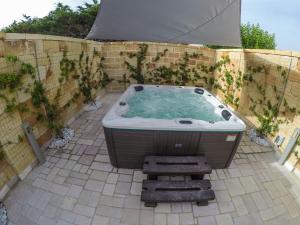 a jacuzzi tub sitting on a patio at Samanà Superior Room in Punta Prosciutto
