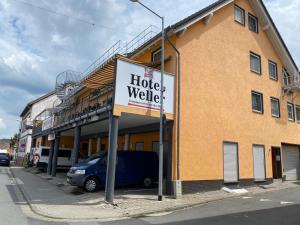 a hotel walkership sign in front of a building at Hotel Weller in Riedstadt +8 photos