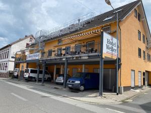 a building with a van parked in front of it at Hotel Weller in Riedstadt