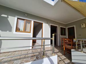 a balcony of a house with a table and chairs at Villa Gezimi in Ksamil