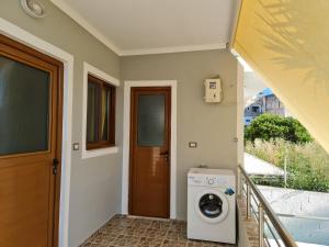 a laundry room with a washer and dryer in a house at Villa Gezimi in Ksamil