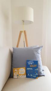 a pillow and two books on a bed with a lamp at Ferienwohnung Amselring in Heringsdorf