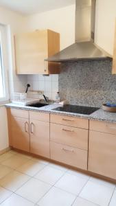 a kitchen with wooden cabinets and a sink at Ferienwohnung Amselring in Heringsdorf