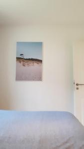 a bedroom with a bed with a picture on the wall at Ferienwohnung Amselring in Heringsdorf