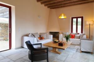 a living room with a couch and a table at Aegea Blue Cycladic Resort in Zorgos 