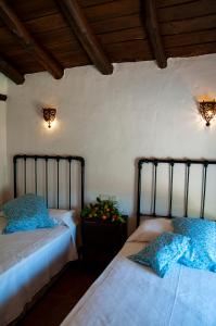 two beds sitting next to each other in a room at Casa Rural Molino de Bony in Júzcar +41 photos