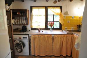 a kitchen with a sink and a window at Casa Rural Molino de Bony in Júzcar