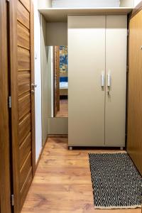 a hallway with a door and a rug at Secret Garden Apartman in Miskolc