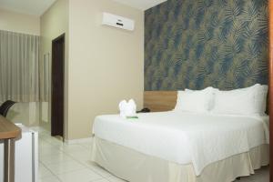 Postel nebo postele na pokoji v ubytování Hotel Mandino