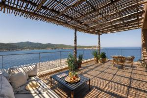 a patio with a view of the water at Six Senses Ibiza in Portinatx