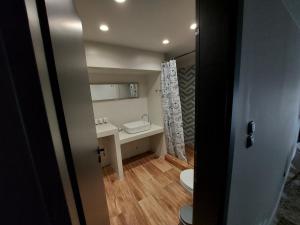 a small bathroom with a toilet and a sink at Ermoupolis hidden gems in Ermoupoli +76 photos