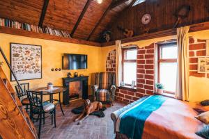 a room with a bed and a dog laying on the floor at Pension Fialka in Český Krumlov