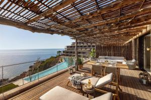 a balcony with a view of the ocean at Six Senses Ibiza in Portinatx