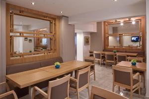 a dining room with wooden tables and chairs at Hotel Hermes in Rhodes Town