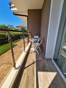 a balcony with a table and chairs on it at Villa Yanevi in Ravda