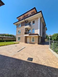 a building with a large driveway in front of it at Villa Yanevi in Ravda