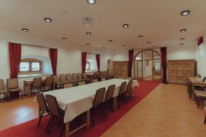 a large room with a large table and chairs at Brigadéros Hotel Brigadír Borsi in Borša