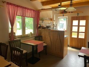a kitchen with a table and a table and chairs at Ubytování U Lva in Žirovnice