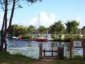 a body of water with boats in a marina at Au Petit Nid de Sanguinet in Sanguinet