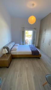 a bedroom with a large bed in a room at Ninemia Apartment in Artemonas