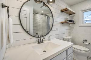 a white bathroom with a sink and a mirror at NEW Modern 5BR House in Monument Near USAFA, Park in Monument