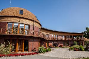 a large brick building with a round roof at Vila Sraige in Palanga
