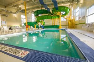 an indoor swimming pool with a water slide at Holiday Inn St Johns, an IHG Hotel in St. John's