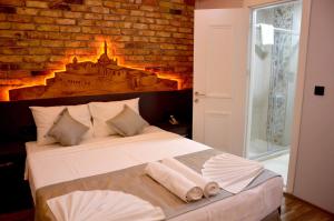 a bedroom with a large bed with a brick wall at A Plus Residence in Istanbul