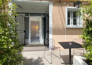 a patio with a table and chairs in front of a house at Hotel Molière in Cannes