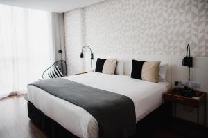 a bedroom with a large white bed and a window at CasaSur Palermo Hotel in Buenos Aires +44 photos