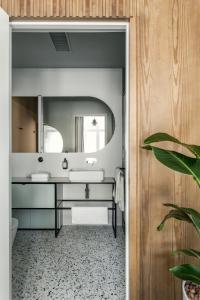 a bathroom with a sink and a mirror at Angelus Apartments in Kraków