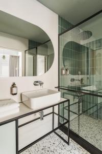 a bathroom with a sink and a shower at Angelus Apartments in Krakow